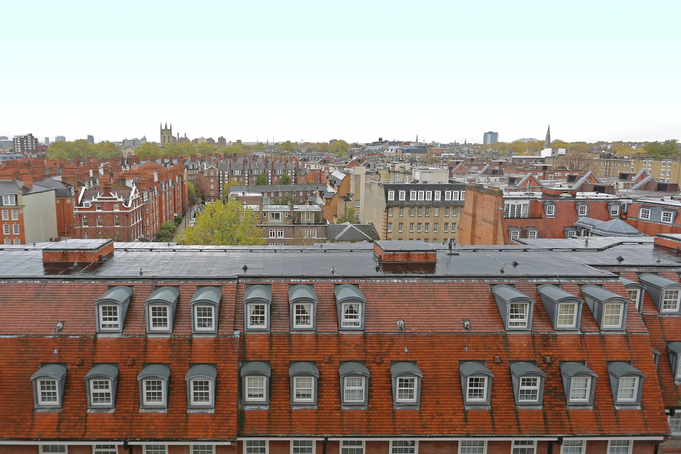 West London rooftops: red brick mansion blocks, dormers and chimney stacks