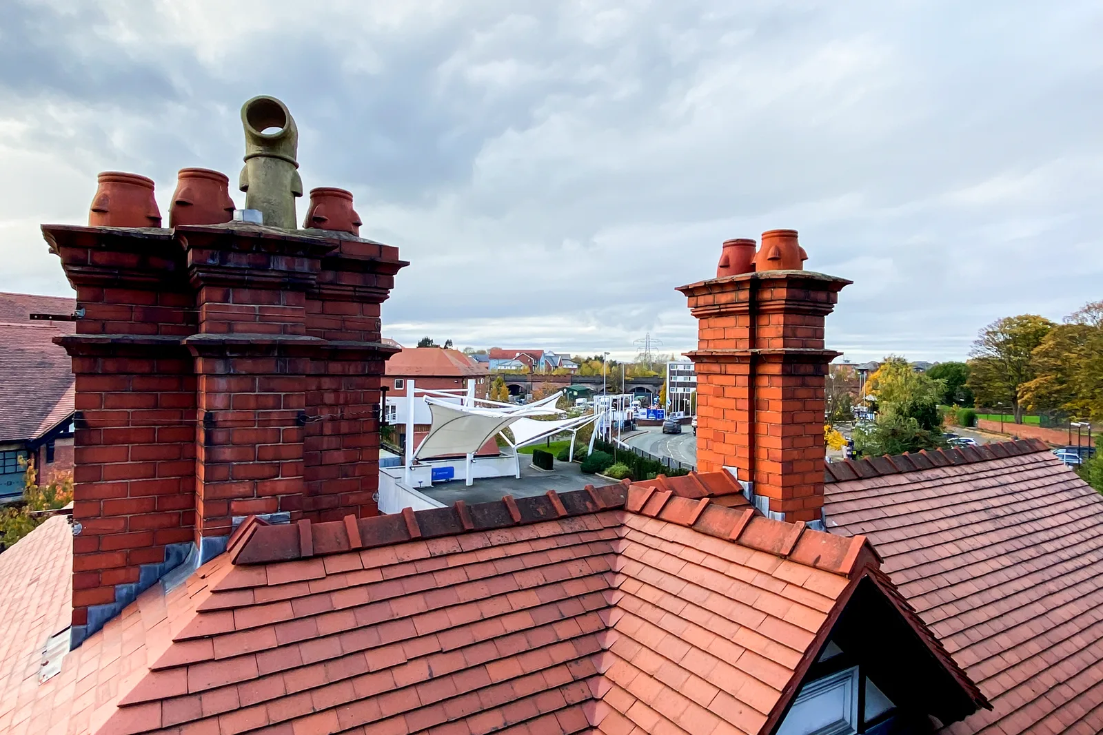 Victorian chimney stacks and clay tiled roofs over west London housing