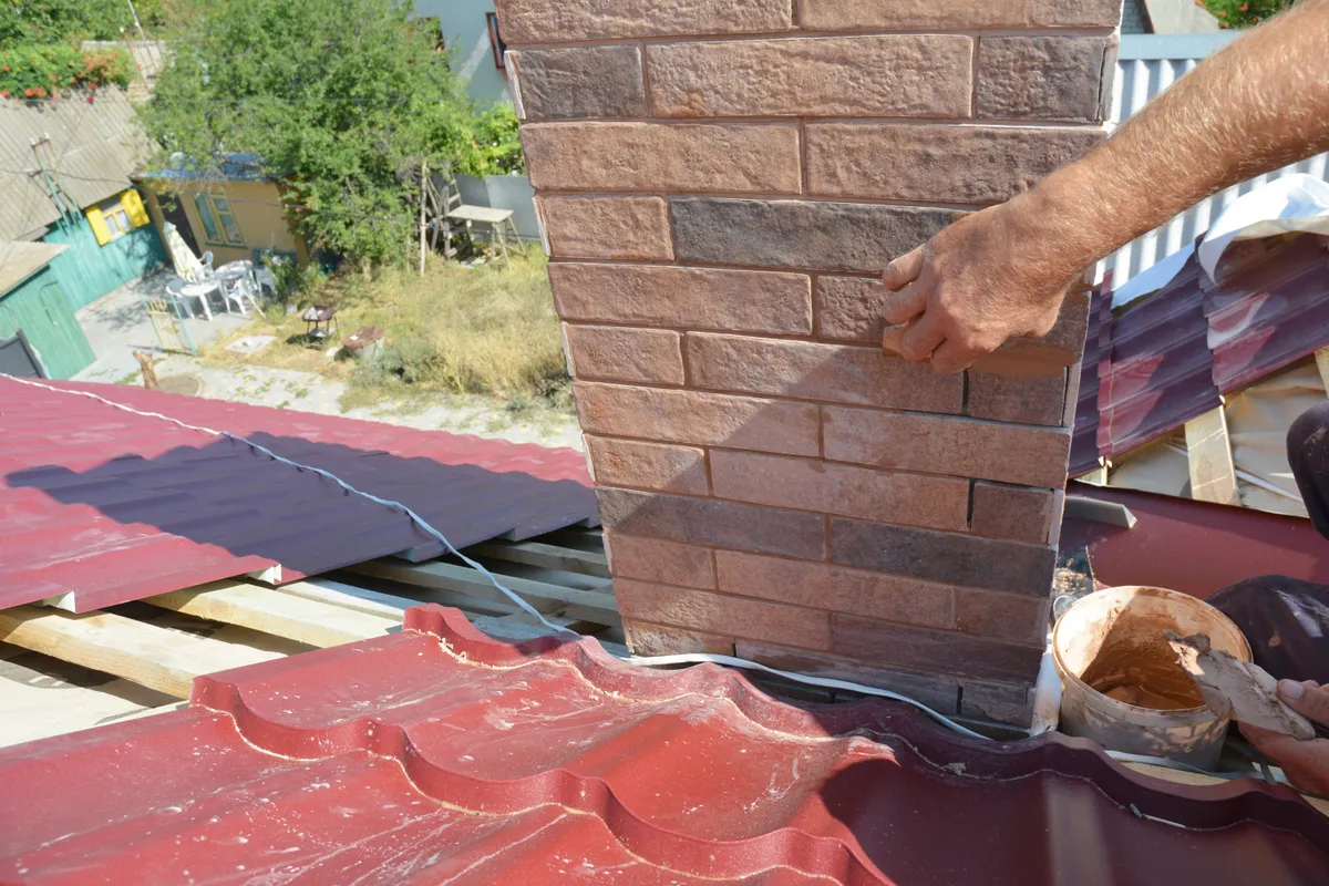 A chimney flashing being dressed into the brickwork