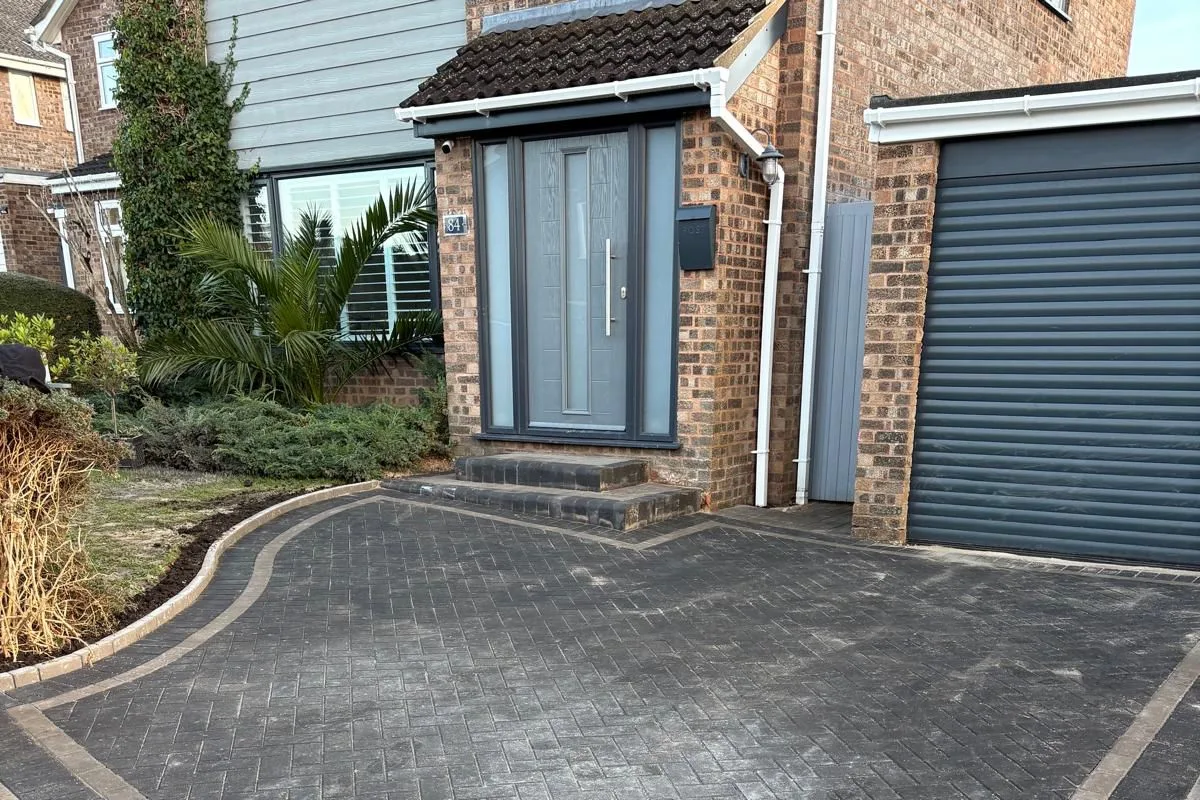 A block paved drive running up to a garage door