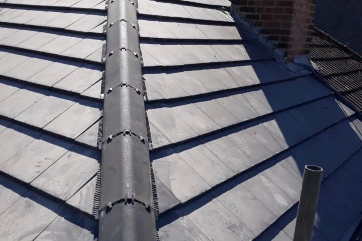 A dry fixed ridge running down a newly tiled roof