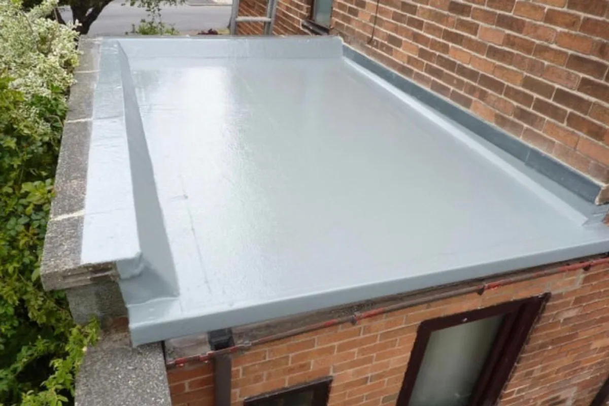 A finished fibreglass roof over a brick bay window