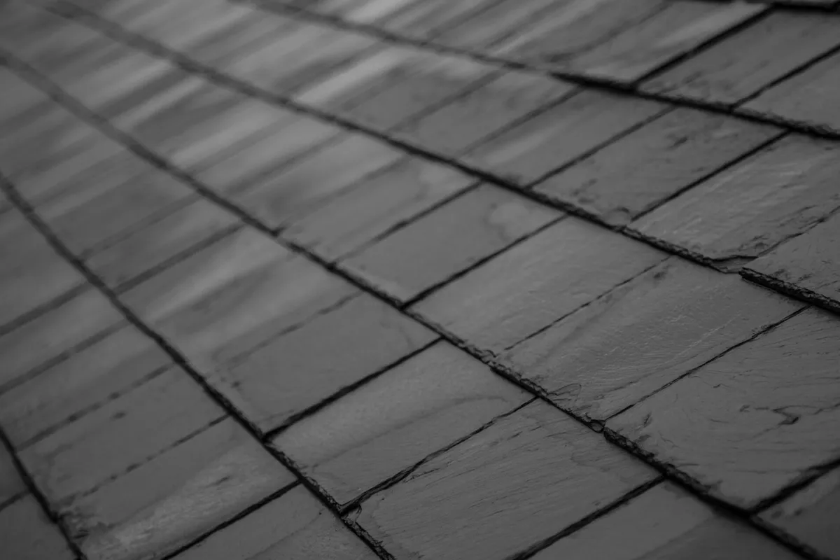 Natural slate laid in even courses on a pitched roof